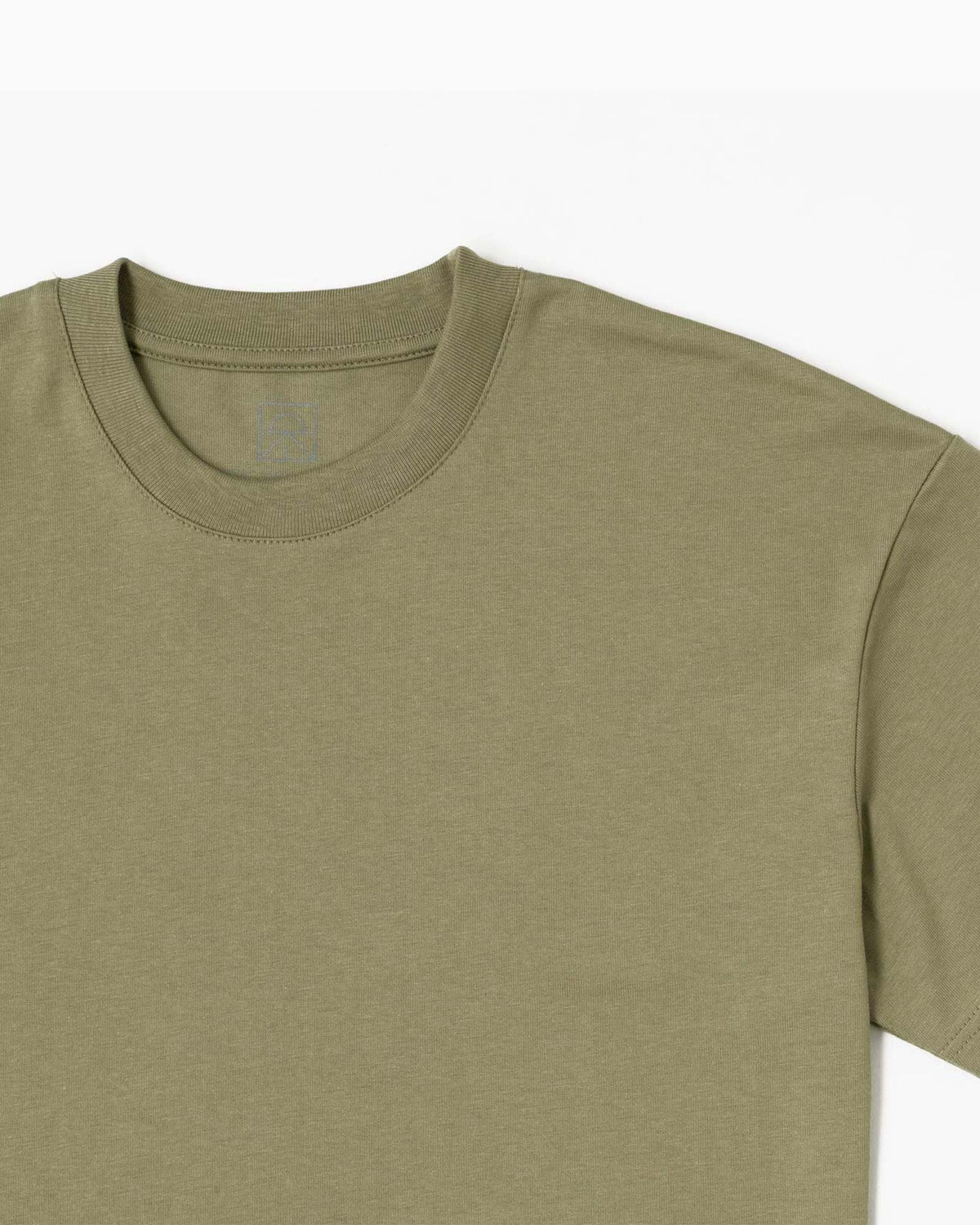 sage green t-shirt still life close up
